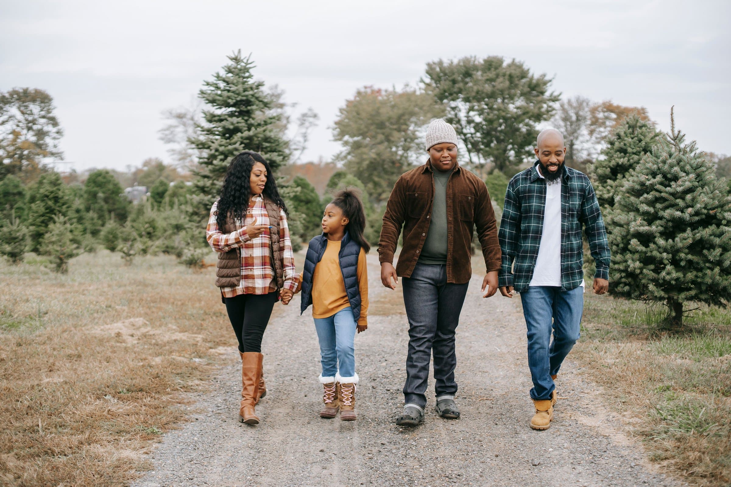 A family walking together outdoors, hand in hand